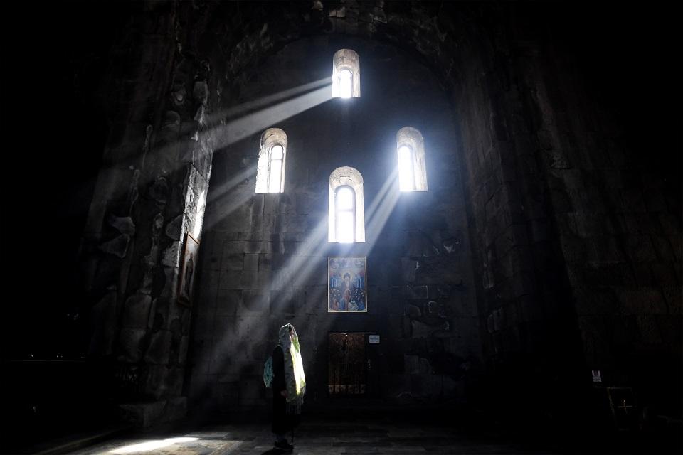 A woman prays in the Sts. Paul and Peter church at the 9th century Tatev monastery of the Armenian Apostolic Church in Syunik, Armenia on October 8, 2017. Kirill Kudryavtsev/AFP