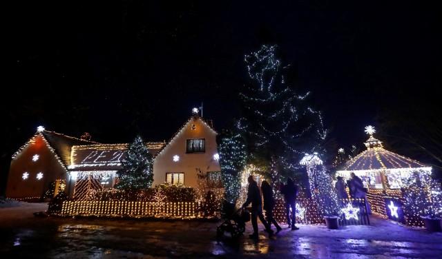 People visit a private house decorated with Christmas lighting in the village of Chotovice near the town of Litomysl, Czech Republic, December 18, 2018. Picture taken December 18, 2018. REUTERS/David W Cerny