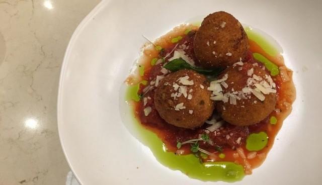 Arancini Alla Bolognese is beef and tomato ragu with Parmigiano Reggiano and EVOO.