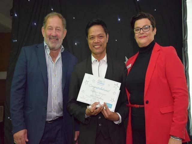 Ridel Francisco proudly holds his trophy and plaque after being recognised as the Nurse of the Year at the 2018 Barchester Care Awards. Photo courtesy of barchester.com.