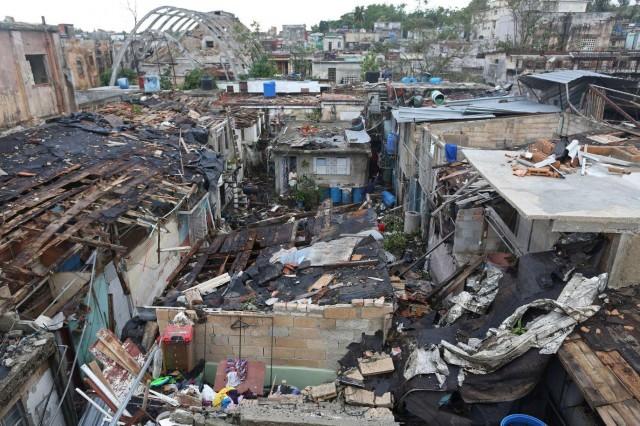 A woman looks out of her house after a tornado ripped through a neighborhood in Havana, Cuba January 28, 2019. REUTERS/Fernando Medina