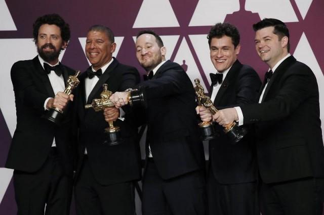 Bob Persichetti, Peter Ramsey, Rodney Rothman, Phil Lord and Christopher Miller pose backstage with the Best Animated Feature Film award for "Spider-Man: Into The Spider-Verse." REUTERS/Mike Segar