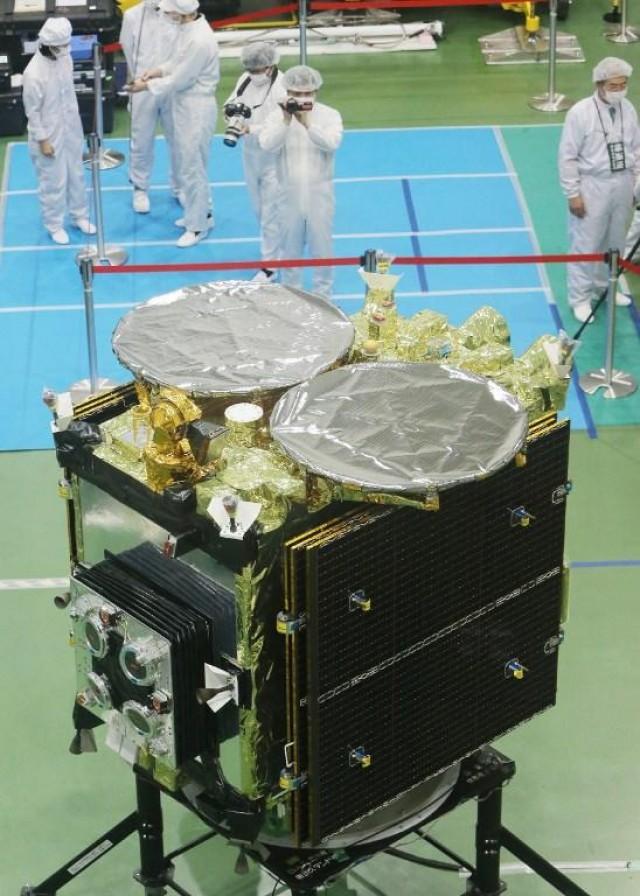 This picture taken on August 31, 2014 shows the new asteroid explorer "Hayabusa-2" during the space probe's unveiling for the press by JAXA, at Japan Aerospace Exploration Agency (JAXA) facility in Sagamihara, suburban Tokyo. JAXA will launch the Hayabusa-2 later this year to bring back samples of the targeted astroid "1999 JU3" AFP PHOTO / JIJI PRESS JAPAN OUT JIJI PRESS / AFP