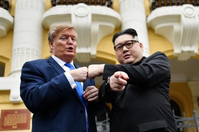 US President Donald Trump impersonator Russel White (L) and North Korean leader Kim Jong Un impersonator Howard X (R) pose together for photographs outside the Opera House in Hanoi on February 22, 2019. Manan VATSYAYANA / AFP