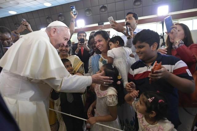 This handout photo released by the Vatican Media, shows Pope Francis blessing children at the Saint Joseph Cathedral in Abu Dhabi on February 5, 2019. HO / AFP / VATICAN MEDIA
