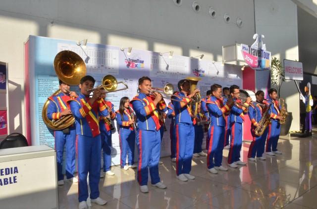 Marching band plays outside to welcome the public during the three-day run of the Travel Tour Expo