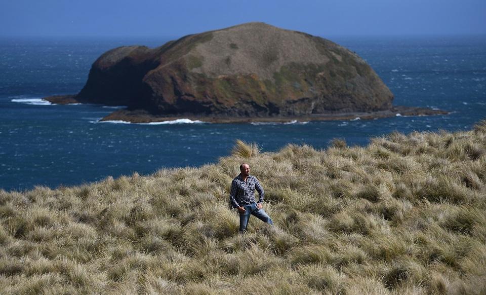 This photo taken on February 24, 2019 shows "rain farmer" Mike Buckby from the Cape Grim Water Company posing in Cape Grim, Tasmania. While the world's most polluted cities struggle to attract talent or manage chronic illnesses, Cape Grim residents have made a virtue of their relatively pristine environment. Buckby has taken things to another level, harvesting water falling "from Earth's purest skies." William West/AFP