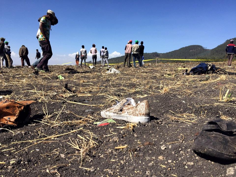 People walk at the scene of the Ethiopian Airlines Flight ET 302 plane crash, near the town of Bishoftu, southeast of Addis Ababa, Ethiopia March 10, 2019. REUTERS/Tiksa Negeri
