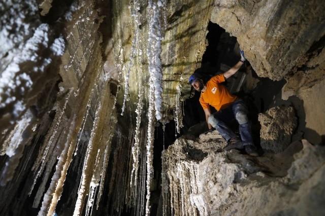 Efraim Cohen of the Malham Cave Mapping Expedition shows journalists salt stalactites in the Malham cave inside Mount Sodom at the southern part of the Dead Sea in Israel on March 27, 2019. Israeli spelunkers announced that the Malham salt cave, a series of canyons running through Mount Sodom, was over ten kilometers long, beating Iran's N3 cave in Qeshm to make it the world's largest. Menahem Kahana/AFP