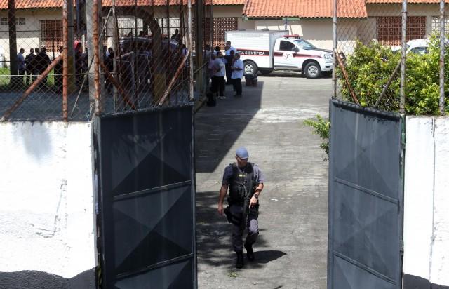 A policeman is seen in the entrance of the Raul Brasil school after a shooting in Suzano, Sao Paulo state, Brazil March 13, 2019. REUTERS/Amanda Perobelli
