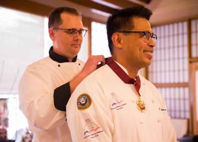 Jerome Feliciano is awarded the World Master Chefs Societyâ€™s medal in culinary excellence during an award ceremony at the Jewel of the East Galley on board U.S. Fleet in Yokosuka, Japan, July 10, 2018. (Photo by Mass Communication Specialist 2nd Class William Collins III)