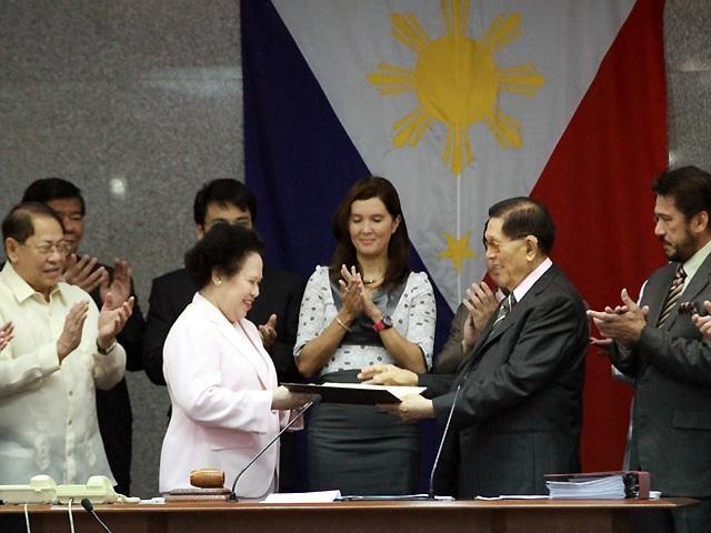 In this photo from January 24, 2012, Senator Miriam Santiago receives a Senate resolution from then-Senate President Juan Ponce Enrile commending her as a newly elected judge of the International Criminal Court. Photo: Benjie Castro