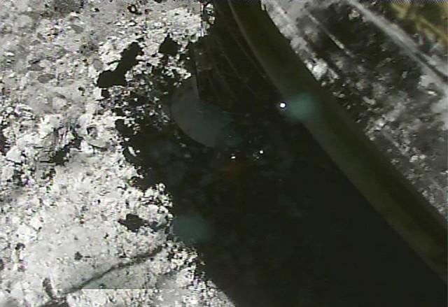 This handout photograph released by the Japan Aerospace Exploration Agency (JAXA) on April 7, 2019 shows an image of the ejector from when the impactor collided with Ryugu's surface, captured by the deployable camera DCAM3 separated from Hayabusa2 probe. The probe on April 5 launched an explosive device at Ryugu, aiming to blast a crater in the surface and scoop up material that could shed light on how the solar system evolved. Handout/JAXA/AFP