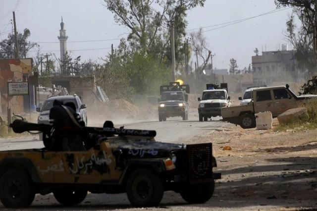 Vehicles belonging to Libyan fighters loyal to the Government of National Accord (GNA) are pictured during clashes with forces loyal to strongman Khalifa Haftar south of the capital Tripoli's suburb of Ain Zara, on April 20, 2019. Forces loyal to Libya's unity government announced today a counter-attack against military strongman Khalifa Haftar's fighters, as clashes south of the capital Tripoli intensified. Mahmud TURKIA / AFP
