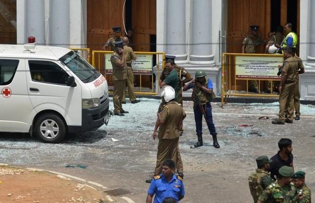 Sri Lankan security personnel stand next to an ambulance outside St. Anthony's Shrine in Kochchikade in Colombo on April 21, 2019 following a blast at the church. At least 138 were killed in bomb attacks on churches and hotels in Colombo. ISHARA S. KODIKARA/AFP