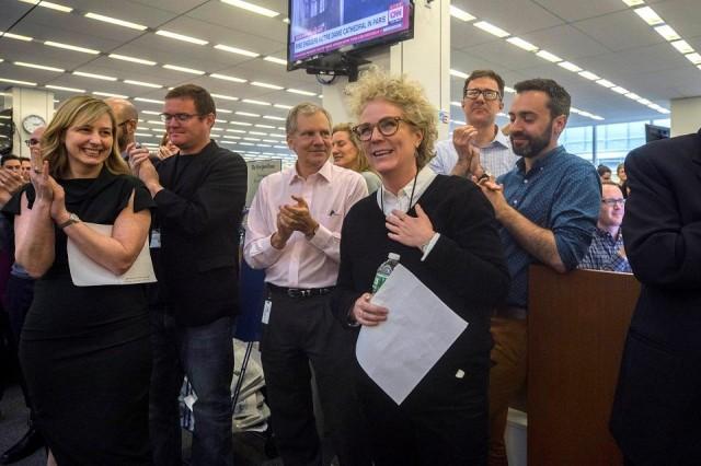 New York Times journalist Susanne Craig, who along with colleagues David Barstow and Russ Buettner won the 2019 Pulitzer Prize for Explanatory Reporting for their forensic review of President Donald Trump&acirc;s family finances, is applauded by New York Times Co. Chairman Arthur Sulzberger Jr. and other colleagues in the newsroom in New York City, U.S. April 15, 2019. Hiroko Masuike/The New York Times via REUTERS