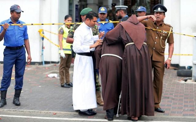 Priests walk into the St. Anthony's Shrine, Kochchikade church after an explosion in Colombo, Sri Lanka April 21, 2019. REUTERS/Dinuka Liyanawatte
