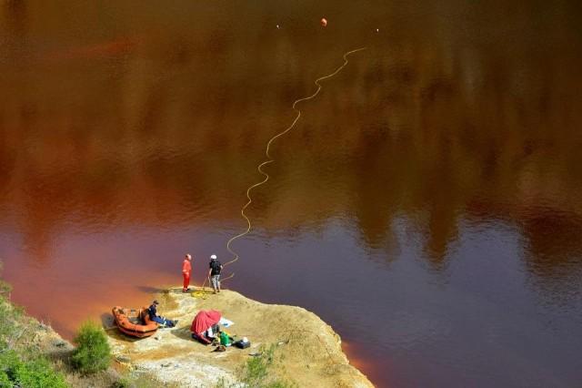 Forensics officers search Kokkinopezoula lake, also known as "red lake", for possible bodies of victims of a suspected serial killer near the village of Mitsero, Cyprus, April 27, 2019. REUTERS/Stefanos Kouratzis