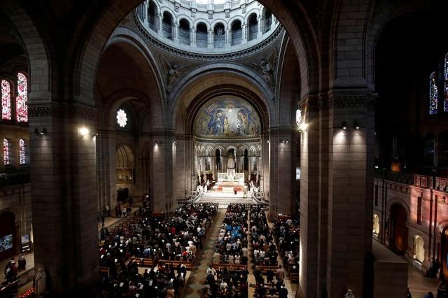 People attend Easter Sunday Mass at Saint-Eustache, days after a massive fire devastated large parts of the structure of the gothic Notre-Dame Cathedral, in Paris, France, April 21, 2019. REUTERS/Gonzalo Fuentes