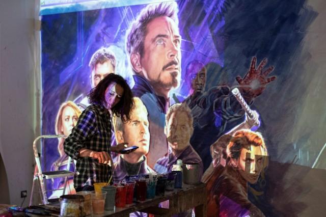 Greek artist Virginia Axioti works on the billboard of the "Avengers: Endgame" movie in Athens, Greece, April 21, 2019. Picture taken April 21, 2019. REUTERS/Alkis Konstantinidis