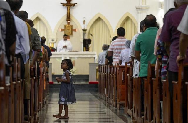 Sri Lankan Catholic devotees pray during a mass at the St. Theresa's Church in Colombo on May 12, 2019 as the country's Catholic churches hold services again for the first time after the Easter attacks amid tight security. Lakruwan Wanniarachchi/AFP