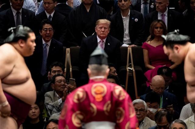 Japan's Prime Minister Shinzo Abe, US President Donald Trump and US First Lady Melania Trump watch a sumo battle during the Sumer Grand Sumo Tournament at Ryogoku Kokugikan Stadium in Tokyo on May 26, 2019. Brendan Smialowski/AFP