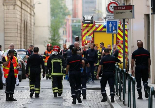 Fire fighters and medics are seen near the site of a suspected bomb attack in central Lyon, France May 24, 2019. REUTERS/Emmanuel Foudrot 