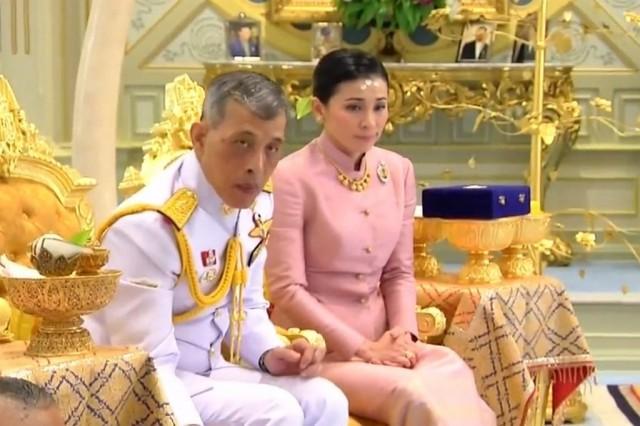 This screengrab from Thai TV Pool video taken on May 1, 2019 shows a ceremony in which Thailand's King Maha Vajiralongkorn "legally married" Suthida Vajiralongkorn na Ayudhya in Bangkok. Thailand announced on May 1, 2019 that King Maha Vajiralongkorn's long-time consort had become his fourth wife, bestowed with the title Queen Suthida -- a surprise move just days before his coronation. Thai TV Pool / AFP