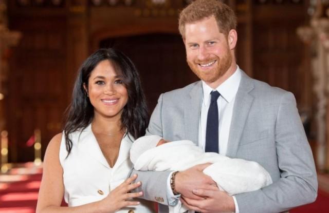 Prince Harry and Meghan, Duchess of Sussex hold their baby son, who was born on Monday morning, during a photocall in St George's Hall at Windsor Castle, in Berkshire, Britain May 8, 2019. Dominic Lipinski/Pool via REUTERS