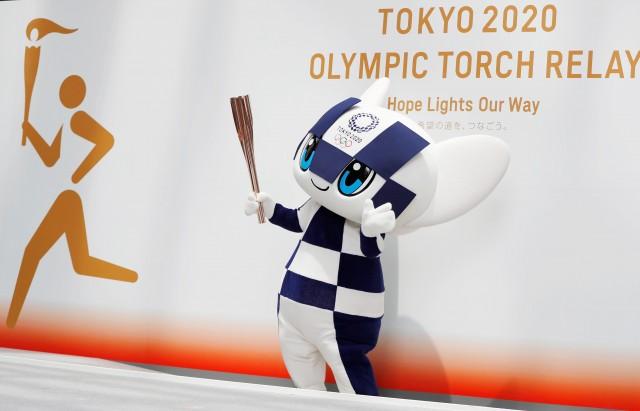 Tokyo 2020 Olympic Games mascot Miraitowa holds the torch of the Tokyo 2020 Olympic Games during a Torch Relay event to mark the 300-day milestone to the starting date of the torch relay, in Tokyo, Japan June 1, 2019. REUTERS/Issei Kato