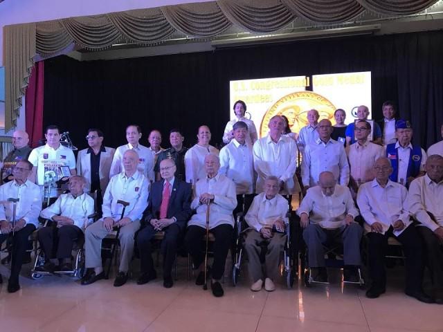 Nineteen living Filipino World War II veterans pose for a photo at an event where they received the US Congressional Gold Medal for their service and sacrifice during the war. Twenty-one others were bestowed the award posthumously.