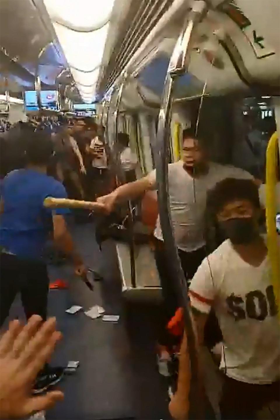 This frame grab taken from video recorded on July 21, 2019 and released by Hong Kong lawmaker Lam Cheuk Ting shows men in white T-shirts attacking pro-democracy protesters at a train at Yuen Long station in Hong Kong following earlier clashes. Handout/Hong Kong lawmaker Lam Cheuk Ting/AFP