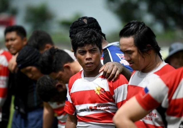 This photo taken on June 15, 2019 shows Lito Ramirez (C) during a rugby match in Silangan, Laguna, south of Manila. Long before Lito Ramirez was one of the Philippines' first homegrown rugby stars he was a six-year-old orphan addicted to sniffing glue, who survived on trash and begging. In 2015, Ramirez was one of the first born and bred Pinoys (Filipinos) to land a spot on the Philippines national squad, the Volcanoes. Noel Celis/AFP