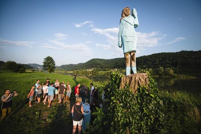 People gather around what conceptual artist Ales "Maxi" Zupevc claims is the first ever monument of Melania Trump, set in the fields near the town of Sevnica, US First Ladyâ€™s hometown, during a small inauguration celebration on July 5, 2019. Jure Makovec/AFP