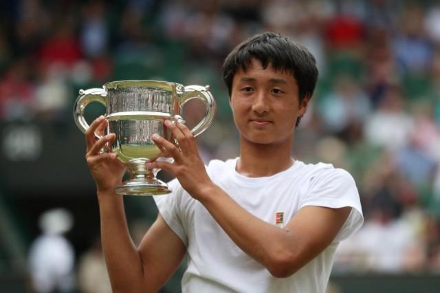 July 14, 2019 Japan's Shintaro Mochizuki poses with a trophy as he celebrates winning the boys' singles final against Spain's Carlos Gimeno Valero REUTERS/Hannah McKay