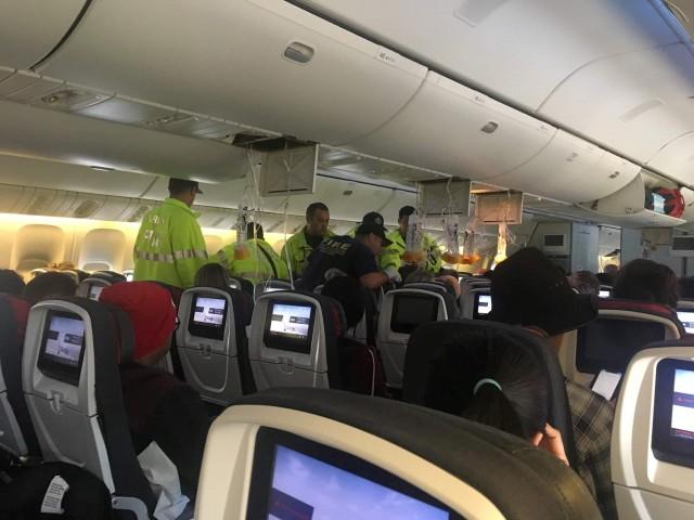 Emergency workers assist passengers of Air Canada AC 33 flight, which diverted to Hawaii after turbulence, at Honolulu airport, Hawaii, US, July 11, 2019 in this image obtained from social media. Australian Band â€“ Hurricane Fall via REUTERS