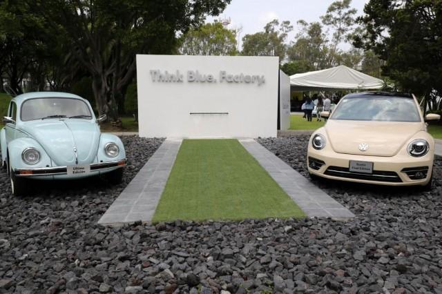 A final edition (R) of the Volkswagen "Beetle" is seen next to a last edition of a previous model of the iconic car, at a factory in Puebla, Puebla State, Mexico, on July 10, 2019. The bug-shaped metallic blue sedan rolled off the production line in central Mexico to rapturous applause, the last of a model first manufactured in the late 1930s. JUAN CARLOS SANCHEZ / AFP