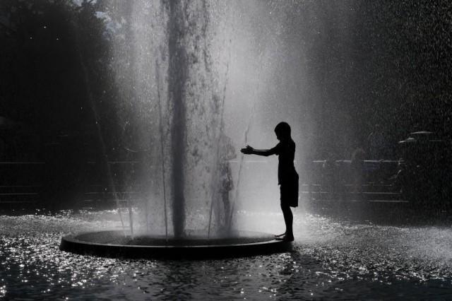 A child cools off in a fountain in Washington Square Park on a hot afternoon in Manhattan on June 27, 2019 in New York City. New York City and much of the East Coast has been experiencing days of heat and bright sun. Spencer Platt/Getty Images/AFP