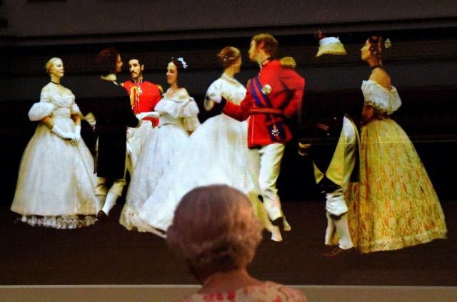 Britain's Queen Elizabeth II looks at a Victorian illusion technique known as Pepper's Ghost of a waltz danced at the Crimean Ball of 1856, in the Ballroom at Buckingham Palace, as part of the special exhibition celebrating the 200th anniversary of the birth of Queen Victoria which marks this year's Summer Opening of Buckingham Palace in London, Britain, July 17, 2019. Victoria Jones/Pool via REUTERS