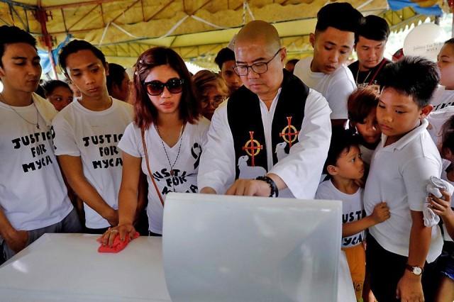 A priest blesses the remains of three-year-old Myca Ulpina before she is laid to rest at a cemetery in Rizal on Tuesday, July 9, 2019. Police said she was used as a human shield by her father, a suspected drug dealer who resisted arrest and opened fire during a buy-bust operation in Rodriguez, Rizal. The girl's mother has rejected the police's claim. Reuters/Eloisa Lopez