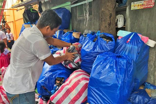 Minor Pangunutan, a vendor, stacks bags of shoes and sandals totalling P200,000 along the walkway leading to his home in San Agustin, Manila, on Monday, July 15, 2019. Pangunutan is one of more than 50 vendors that have been told to leave the Manila City Hall underpass. Tina Panganiban-Perez