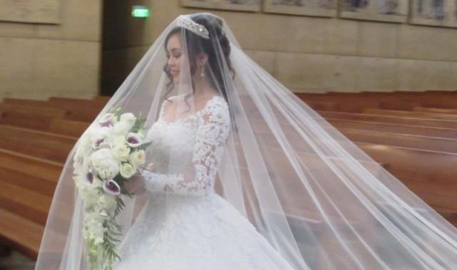 The wedding gown was a long-sleeved off-white layers of silk organza and has thousands of Swarovski crystals. Photo: Ruben Nepales and Janet Susan R. Nepales