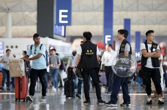 Police patrol the departure hall of the airport in Hong Kong after previous night's clashes with protesters, China August 14, 2019. REUTERS/Thomas Peter 