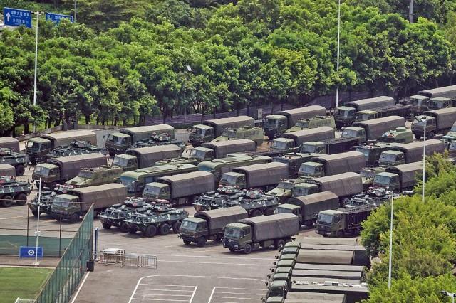 Trucks and armored personnel carriers are seen outside the Shenzhen Bay stadium in Shenzhen, bordering Hong Kong in China's southern Guangdong province on Thursday, August 15, 2019. Thousands of Chinese military personnel held drills at a sports stadium in southern China on August 15 morning, raising the fear of military intervention in Hong Kong, which has seen weeks of civil unrest. AFP