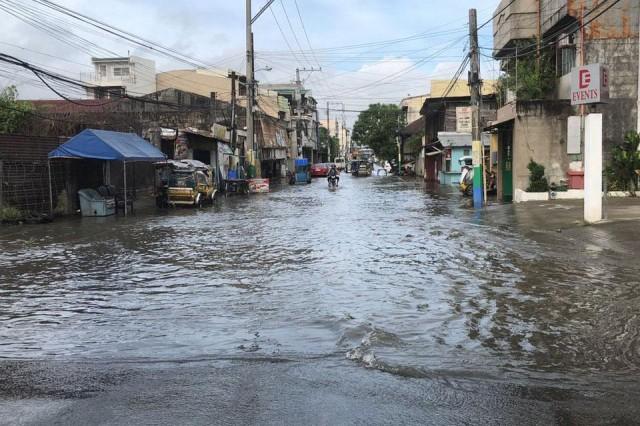 Only a few vehicles traverse a flooded street in Dagupan City, Pangasinan as floods caused by Typhoon Jenny's rains inundate many parts of the city on Wednesday, August 28, 2019. Jonathan Andal