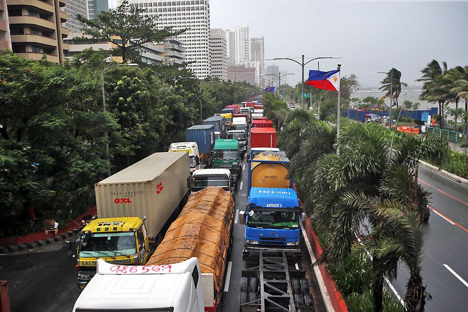 Trailer trucks occupy the north bound lane of Roxas Boulevard in Manila, causing a gridlock, following Port Area Management's suspension of its operations due to bad weather condition on Friday, August 9, 2019. Danny Pata 