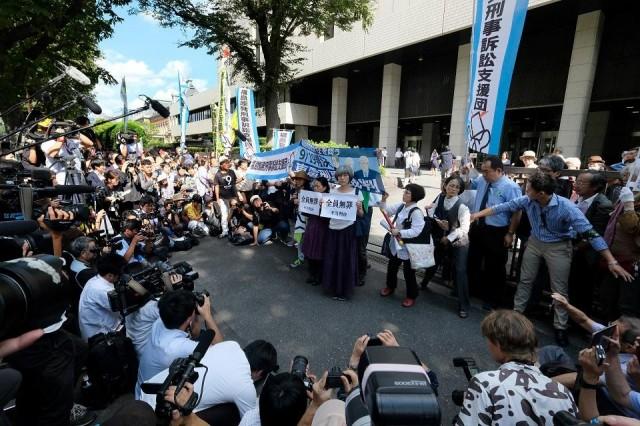 Activists hold banners and placards during a rally in front of the Tokyo District Court on September 19, 2019, after it acquitted three former officials of the Tokyo Electric Power Company (TEPCO), the firm that operated the Fukushima nuclear plant, in the only criminal trial to stem from the 2011 nuclear disaster. Kazuhiro Nogi/AFP