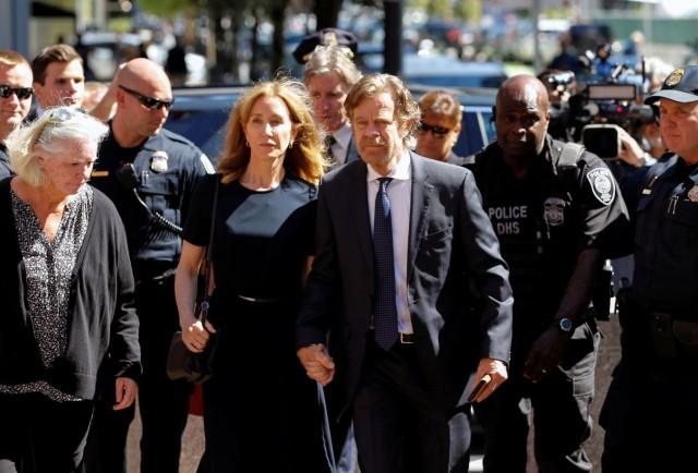 Actress Felicity Huffman arrives at the federal courthouse with her husband William H. Macy, before being sentenced in connection with a nationwide college admissions cheating scheme in Boston, Massachusetts, U.S., September 13, 2019. REUTERS/Katherine Taylor