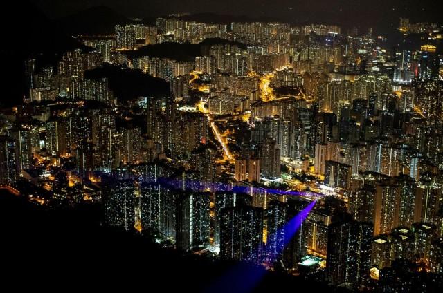 Laser beams, coming from the residential buildings in Kowloon district, are seen as anti-government protesters gather at Lion Rock, in Hong Kong, China September 13, 2019. REUTERS/Athit Perawongmetha