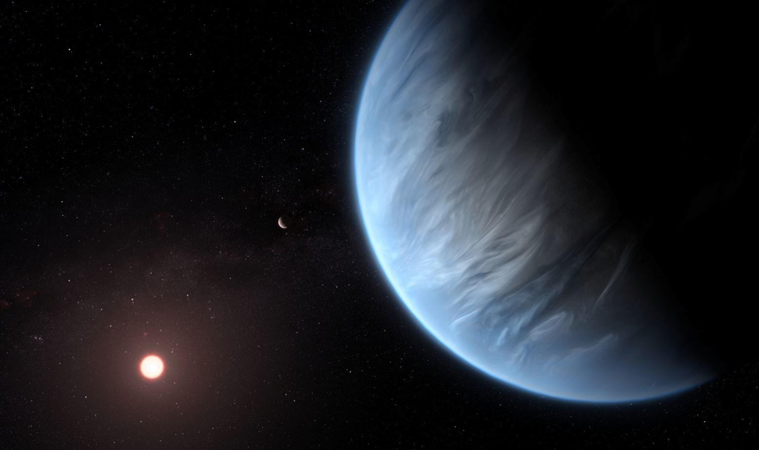An artist's impression released by NASA on September 11, 2019 shows the planet K2-18b, its host star and an accompanying planet. Courtesy ESA/Hubble/M. Kornmesser/NASA Handout via REUTERS